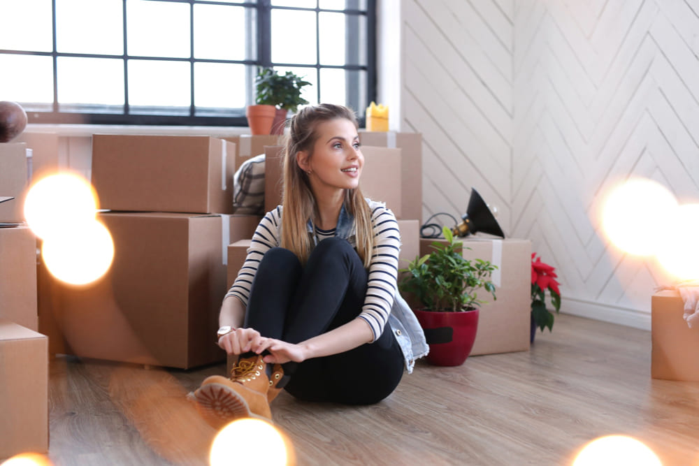 woman-finished-with-cargo-packages-is-sitting-boxes-floor-2